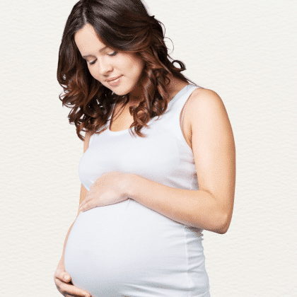 Non-Invasive Prenatal Paternity test- A picture showing a Pregnant Lady holding her Baby bump. A Non-Invasive prenatal paternity test helps to determine the Paternity of unborn child by matching the fetal dna isolated from Mother's blood sample and matched with the DNA profile of the alleged father.
